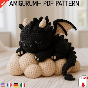 May include: A black crocheted amigurumi dragon sleeping on a beige crocheted cloud. The dragon has closed eyes and a small horn on its head. The pattern is available as a PDF download. "AMIGURUMI - PDF PATTERN" is written above the dragon.