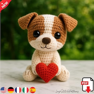 Può includere: Un cane all'uncinetto con pelo marrone e bianco, che tiene un cuore rosso. Il cane ha grandi occhi neri e un naso marrone. L'immagine include il testo "LoopStitchPatterns" e un'icona "PDF".