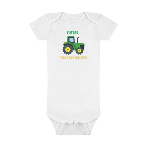 May include: White baby onesie with a green tractor and the text "FUTURE TRACTOR DRIVER" in green and yellow.