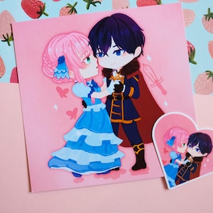 May include: A square print and heart-shaped sticker featuring an anime-style couple in an embrace. The print shows a man in a dark blue uniform and a woman in a blue dress. The background is pink with butterfly and sword details.