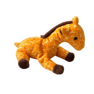 May include: A plush giraffe toy in a lying down position. The giraffe has an orange body with brown spots, a brown mane, and brown hooves. The toy is made of soft material and has black button eyes.