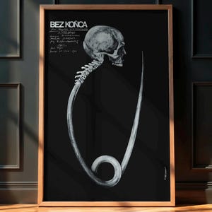 May include: A framed black and white art print. The artwork depicts a skull and spine connected to a large safety pin shape. The print includes the text "BEZ KONCA" at the top and handwritten text on the left. The print is in a wooden frame.