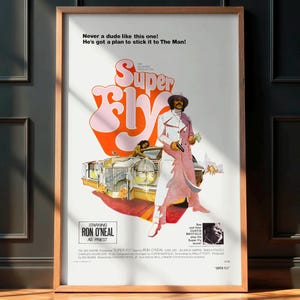 May include: Framed vintage movie poster for "Super Fly" starring Ron O'Neal. The poster has a retro design with the title in large, stylized lettering. The image shows a man in a white suit and pink coat, with a car and cages in the background.