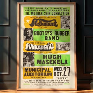May include: A framed vintage concert poster for The Mother Ship Connection, featuring Parliament, Bootsy's Rubber Band, Funkadelic, and Hugh Masekela. The poster has a yellow, green, and white colour scheme, with the date of the show as Wednesday, October 27.