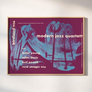 May include: A framed poster with a deep purple background and teal brushstroke designs. The poster features the text "birdland 1956" and "modern jazz quartett." Names of jazz musicians are listed below the title, including Lester Young and Miles Davis.