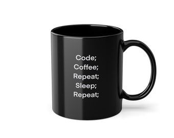 May include: Black coffee mug with white text that reads "Code; Coffee; Repeat; Sleep; Repeat;"