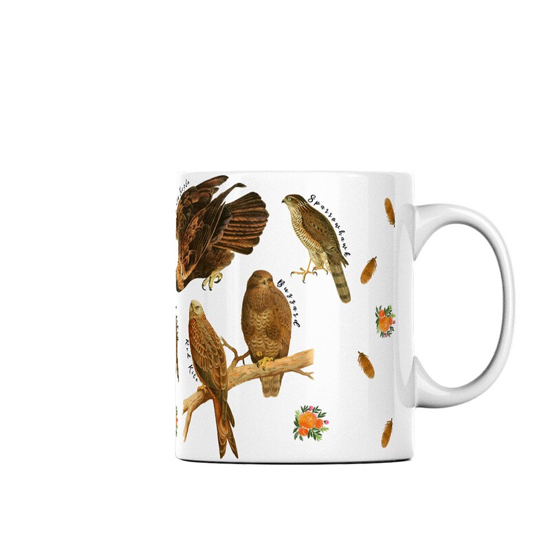 (Right side of mug) A white ceramic mug featuring labelled vintage art of carnivorous birds of prey. These include a hobby, peregrine falcon, osprey, 
kestrel, merlin, golden eagle, red kite, buzzard and sparrowhawk. Water colour feathers and flowers are arranged around the birds.