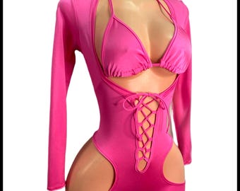 May include: A hot pink bodysuit with long sleeves and a lace-up detail at the front. The bodysuit has cutouts on the sides and a matching triangle bra.