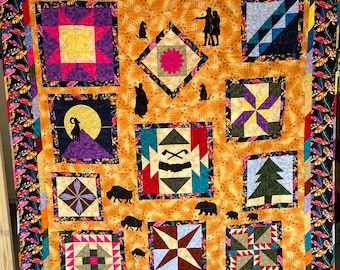 May include: A colorful quilt with a variety of geometric patterns and silhouettes of animals and people. The quilt is made of different fabrics in shades of red, blue, green, yellow, purple, and brown. The quilt is surrounded by a black border with a feather design.