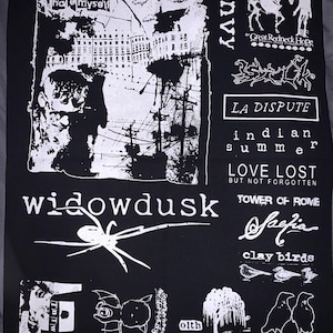 May include: Black fabric with white graphic designs and text. Features the words "hate myself", "Envy", "widowdusk", "LA DISPUTE", "indian summer", "LOVE LOST", "TOWER OF ROME", "Safia", "clay birds", and "FUNERAL DINER". Includes illustrations of a spider, birds, and other imagery.
