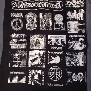 May include: Black fabric patch featuring multiple white graphic designs and text. The patch includes band logos and names such as "FIOTGASATTACK", "NAUSEA", "DISRUPT", and "TOTALITAR". The overall theme is punk rock and hardcore music.