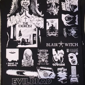 May include: Black fabric featuring white graphic illustrations of horror movie titles and imagery. Includes images from "The Exorcist", "Carrie", "The Evil Dead", "Friday the 13th", and "Scream". Also features the text "I Want to Believe".