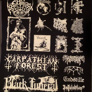 May include: Black fabric patch featuring multiple white logos and illustrations, including band names and gothic imagery. The patch has a rectangular shape and is likely for a jacket or bag.