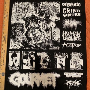 May include: A black fabric patch featuring white screen-printed graphics, including band logos and horror-themed illustrations. Text includes Melting Rot, Grind Whore, Human Equence, Agitate, Hong Kong, Bulma, and Gourmet. A ruler shows a height of 24 inches.