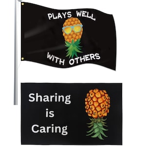 May include: Black flag with a pineapple wearing sunglasses and the text "PLAYS WELL WITH OTHERS". Below is a black flag with the text "Sharing is Caring" and a pineapple illustration.
