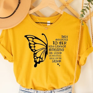 They Whispered to Her You Cannot Withstand The Storm She Whispered Back I am the Storm Shirt, Butterfly Faith Tees