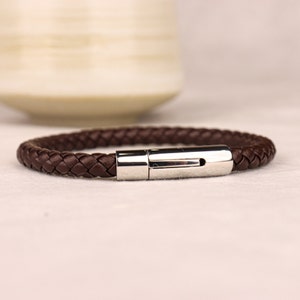 May include: A brown leather bracelet with a silver clasp.