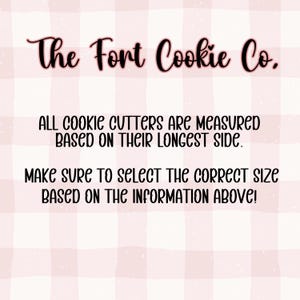 May include: A pink and white checkered background with the text "The Fort Cookie Co." in a cursive font. The text below states that cookie cutters are measured by their longest side and to select the correct size.