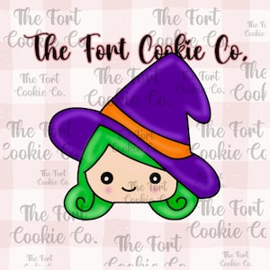 May include: A cartoon witch face cookie cutter with a purple witch hat, orange band, and green hair. The face has black eyes and a small smile. The text "The Fort Cookie Co." is in the background.