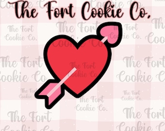 May include: A red heart with an arrow through it, with the text "The Fort Cookie Co." above it. The background is a pink and white gingham pattern.