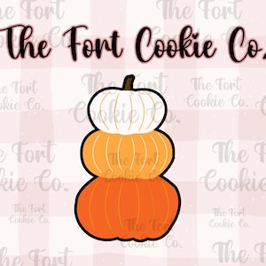 May include: A stack of three pumpkin-shaped cookies, the bottom one is orange, the middle one is orange and white, and the top one is white. The cookies are decorated with lines and have a stem on top. The text "The Fort Cookie Co." is written above the cookies.