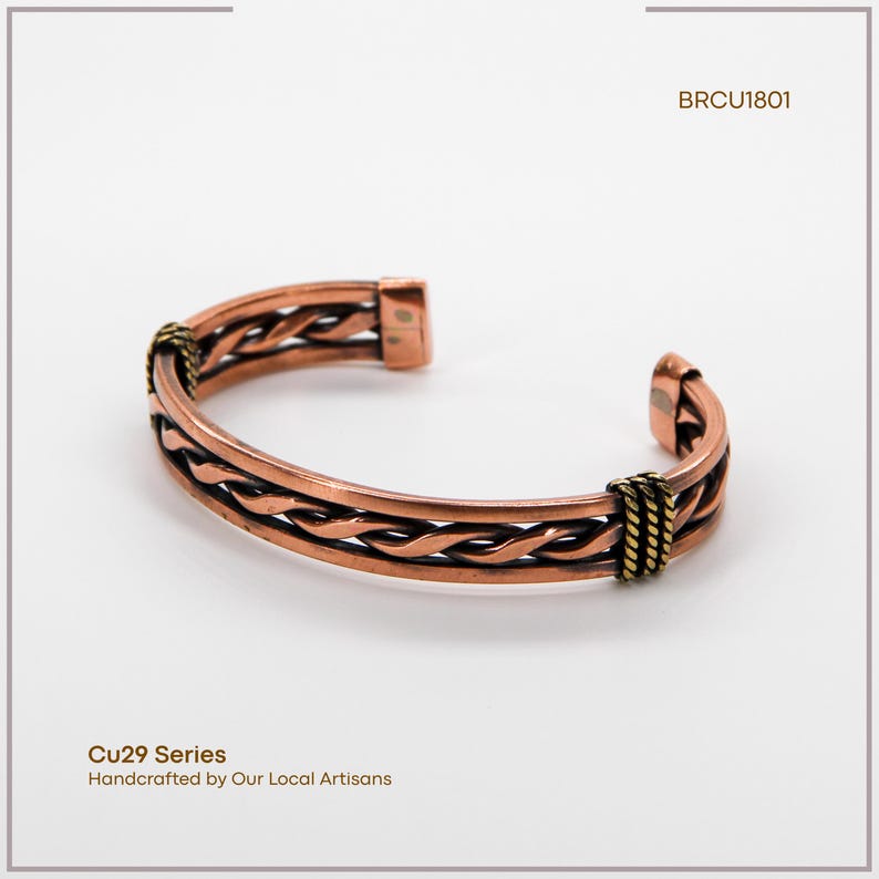 May include: Copper cuff bracelet with a woven design and gold-colored accents. The bracelet has the text "Cu29 Series Handcrafted by Our Local Artisans" and the code "BRCU1801".