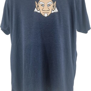 May include: A navy blue t-shirt featuring a cartoon illustration of a white-haired, pointy-eared man with a beard and moustache.