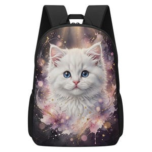 May include: A black backpack featuring a central graphic of a fluffy white kitten with bright blue eyes. The kitten is surrounded by a watercolour-style background in shades of purple and pink, accented with small golden stars and light bokeh circles.