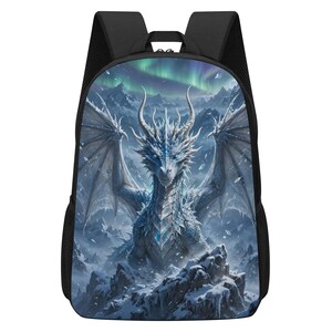 May include: A black backpack featuring a printed graphic on the front panel. The image displays a white, crystalline dragon with large wings perched on a snowy mountain peak. The background shows a dark, icy landscape under a vibrant green aurora.