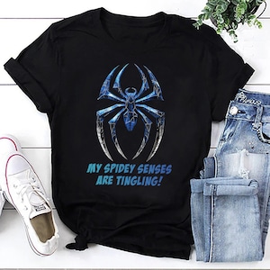 May include: Black t-shirt with a blue and gray spider web design and the text "My Spidey Senses Are Tingling!"