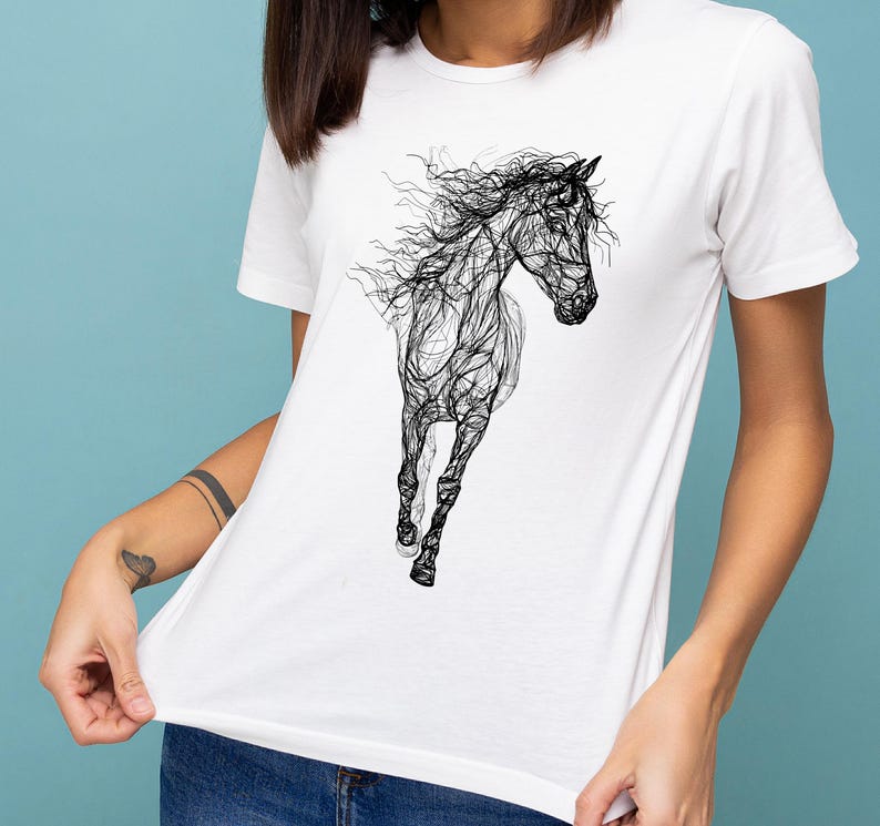 May include: White t-shirt featuring a black line art illustration of a running horse. The design showcases the horse's form with flowing lines, creating a dynamic and artistic representation. The shirt is a classic crew neck style.