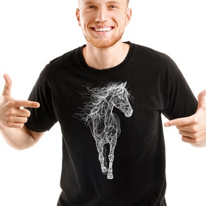 May include: Black t-shirt featuring a white, stylized illustration of a running horse. The horse design has a flowing, almost ethereal quality. The shirt is a classic crew neck style.