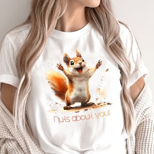May include: White t-shirt with a cartoon squirrel graphic and the text "nuts about you!"