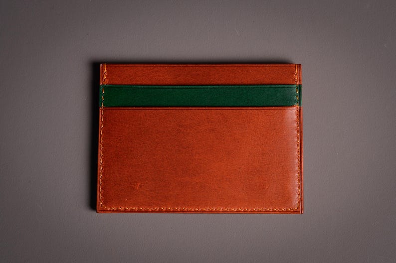 Découvrez notre portefeuille fin en cuir, conçu pour homme ou femme, alliant élégance et praticité. Fabriqué à la main avec un cuir 100 % premium, cet accessoire sophistiqué dispose d'une capacité de rangement pour environ 4 cartes de crédit. Son design épuré et chic s'adapte parfaitement à votre style au quotidien. Offrez-vous ou à un proche ce portefeuille artisanal, alliant style et fonctionnalité. Parfait pour un usage quotidien ou comme cadeau spécial!