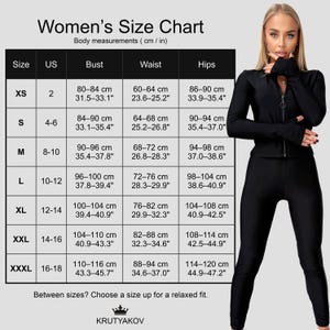 May include: A black athletic outfit with a size chart. The chart displays body measurements in centimeters and inches for sizes XS to XXXL. The model is wearing a black zip-up jacket and matching leggings.