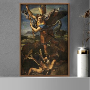 May include: A framed painting depicting an angel with wings, holding a spear, standing over a fallen demon. The angel is wearing armor and a blue robe. The painting is set against a background of a landscape with clouds.