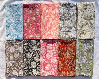 May include: A collection of ten rectangular fabric napkins arranged in two rows, each featuring a distinct floral block print pattern in various colours including light blue, pink, coral, grey, olive, brown, black, red, and sage green on white.