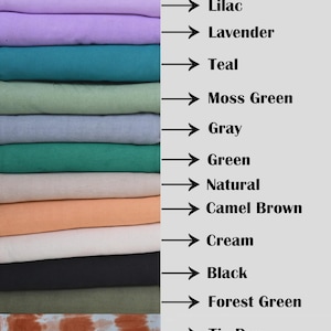 Puede incluir: Una pila de muestras de tela en varios colores, incluyendo lila, lavanda, verde azulado, verde musgo, gris, verde, natural, marr&oacute;n camel, crema, negro, verde bosque y tie dye. Cada color est&aacute; etiquetado con una flecha.