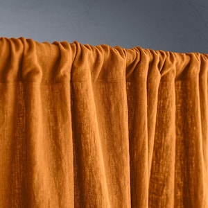 May include: A white ceramic mug with a black handle and the text "But First, Coffee" in a bold, black font. The mug is on a wooden surface. The mug is approximately 10 cm tall.