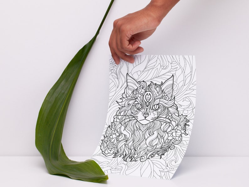 May include: A black and white line drawing of a cat's head with intricate details. The cat has a third eye on its forehead and is surrounded by floral patterns.