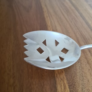 Silver-plated serving spoon from France in art déco style, with authenticity stamps.
