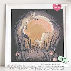 May include: A cross-stitch pattern featuring two foxes in a moonlit forest scene. The foxes are white with pink accents and are standing on their hind legs. The moon is a large, orange circle with a soft glow. The forest is dark and mysterious, with tall trees and lush foliage. The pattern is titled "SAGA" and is available as a PDF download.