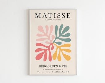 May include: A poster with a minimalist design featuring a stylized floral motif in shades of pink, red, yellow, and green. The poster is titled "Matisse" and includes the text "Papiers Découpés" and "Berggruen & Cie".