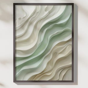 May include: Abstract art print in a dark brown frame. The artwork features layered, undulating shapes in shades of white, beige, and green, creating a sense of depth and movement. The composition is a modern, minimalist design.