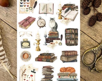 May include: Vintage Book Nook sticker sheet featuring illustrations of books, candles, a cat, a cup of tea, and a vintage clock. The sheet has the text "Vintage Book Nook" at the top.