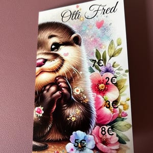 Könnte beinhalten: Ein niedliches Cartoon-Otter mit einem rosa Herzen auf der Nase, umgeben von bunten Blumen. Die Blumen haben Preisschilder, darunter 7€, 2€, 3€, 8€ und 5€. Das Bild trägt den Text "Otti Fred" oben.