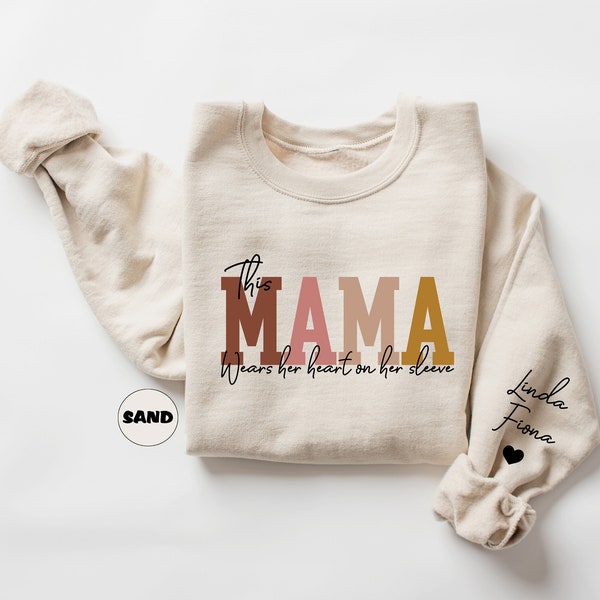 Custom This Mama Wears Her Heart On Her Sleeve Sweatshirt, Personalized Mom Hoodie With Kids Names, Cute Momma Outfit, Mothers Day Gift Idea