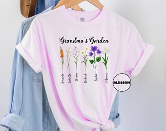 May include: Pink t-shirt with the text "Grandma's Garden" and a row of flowers with names underneath each flower. The names are:  Amadeo, Isabelle, Henry, Richard, Sophia, and Mason.