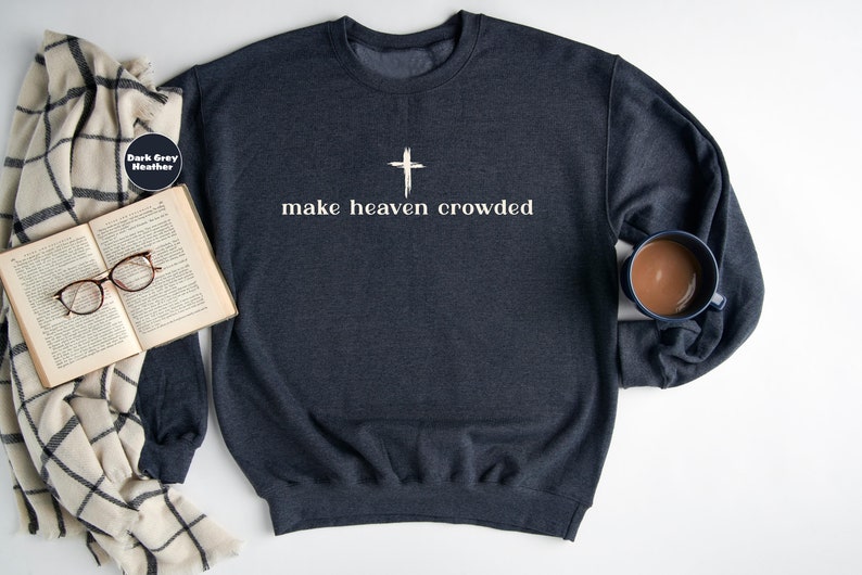 May include: Dark grey heather sweatshirt with a white cross and the text "make heaven crowded".