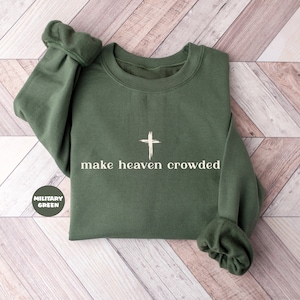 May include: A green sweatshirt with the text "make heaven crowded" and a white cross graphic.